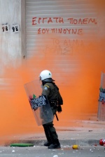 Demonstrations and riots during the second day of the general strike against the second Memorandum///Riot policeman in front of a graffity that writes ‘‘Worker fight. They drink yor blood‘‘
 © Maro Kouri