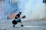 Demonstrations and riots during the second day of the general strike against the second Memorandum///Protester throws a heater on the road to prevent the riot police attack
 © Maro Kouri