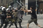 Riots during a rally against plans for new austerity measures///Protesters clash with riot police in front of the Greek parliament
 © Maro Kouri